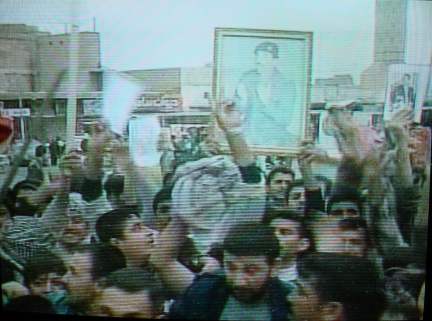 Followers in worship of Saddam